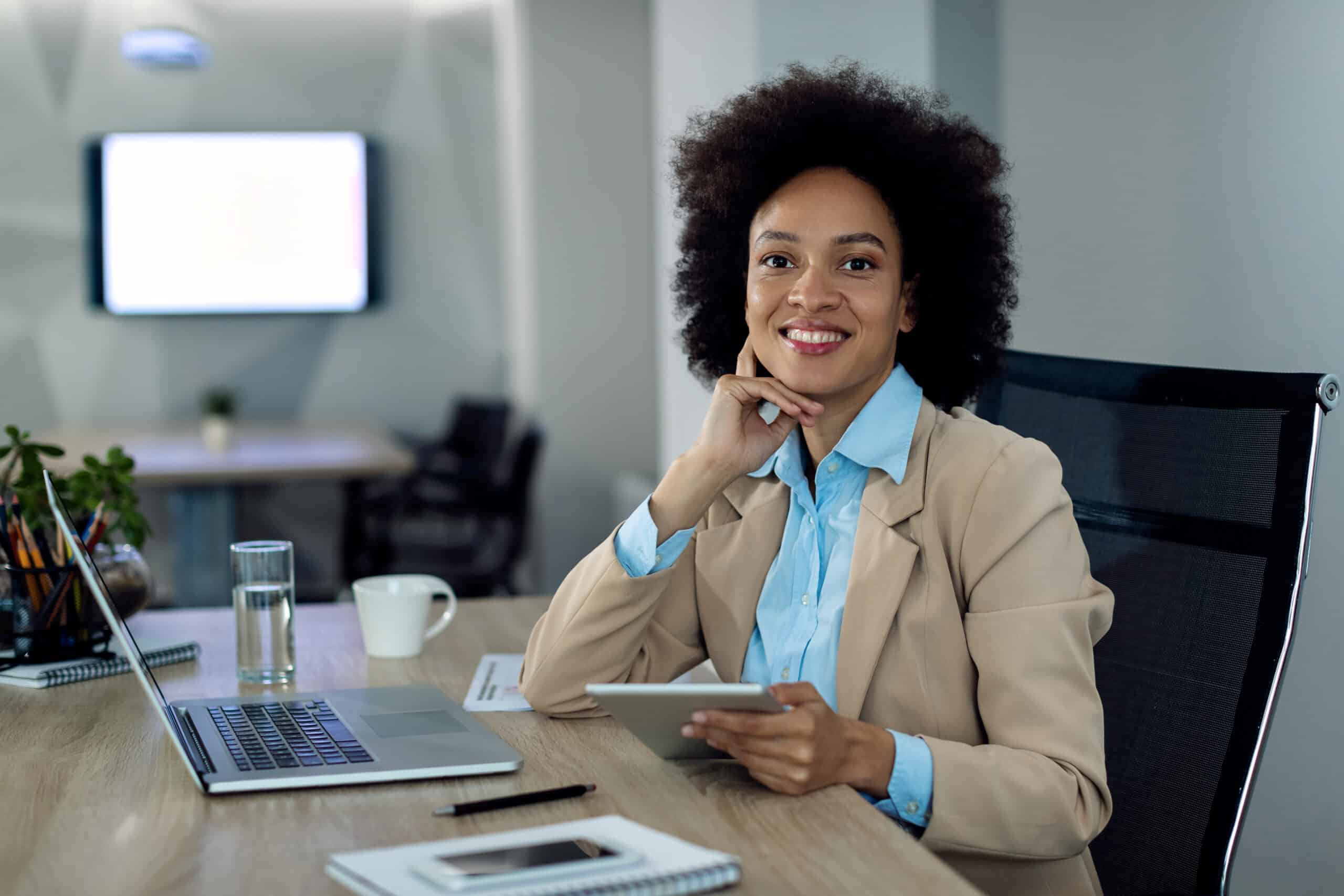 happy african american businesswoman working on touchpad in the