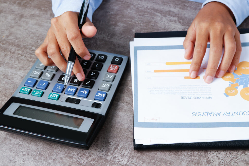 closeup of analyst using calculator